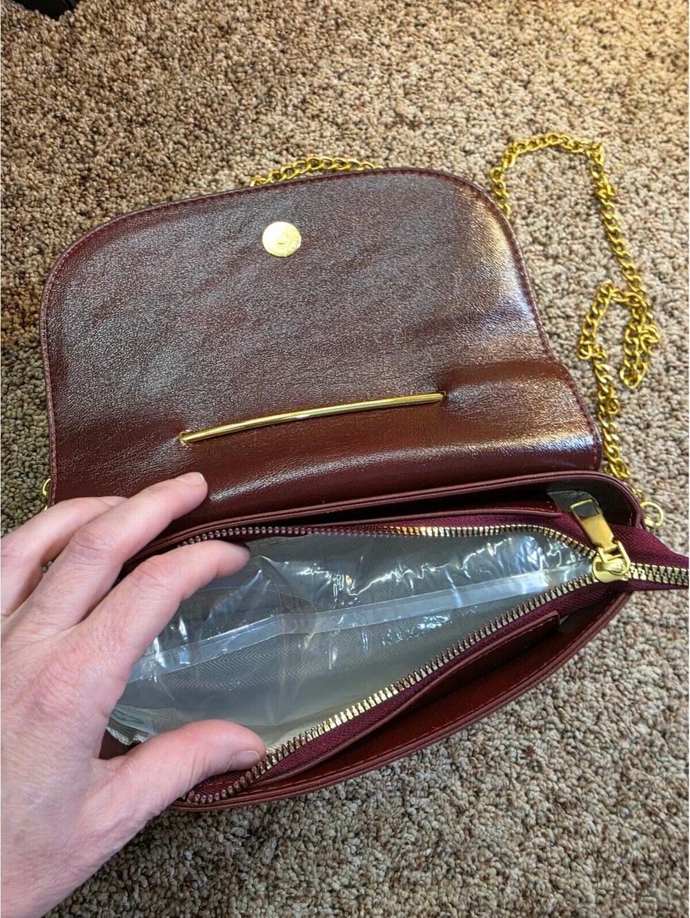 Elegant Burgundy Faux Leather Clutch Bag with Gold Chain and Safety Pin Detail